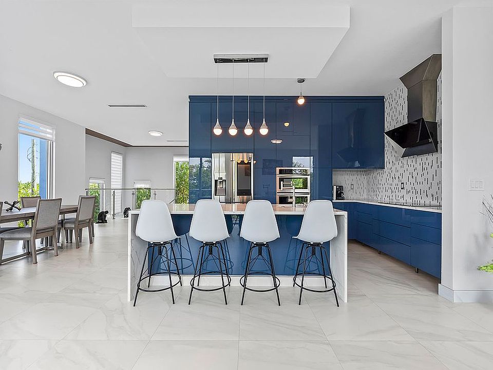 Modern blue and white kitchen with quartz island